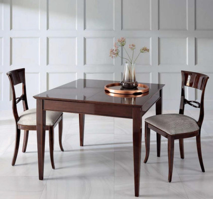 Elegant dining table with chairs in dark brown color with shiny surface