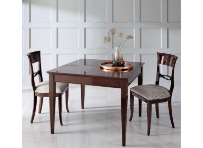 Elegant dining table with chairs in dark brown color with shiny surface