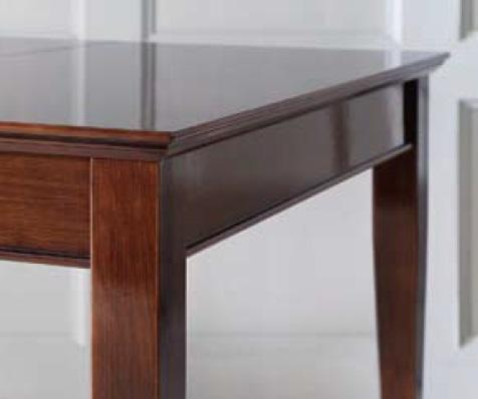 Elegant dining table with chairs in dark brown color with shiny surface