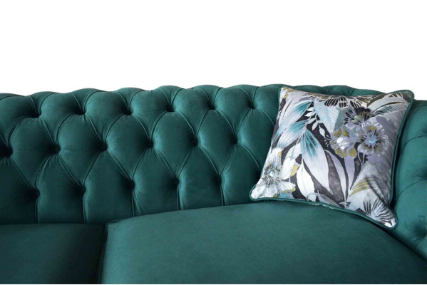 A vibrant three-seater Chesterfield sofa in a delicate emerald color with a floral pattern