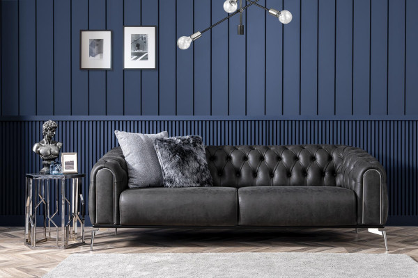 Black Chesterfield style four-seater straight sofa for the living room