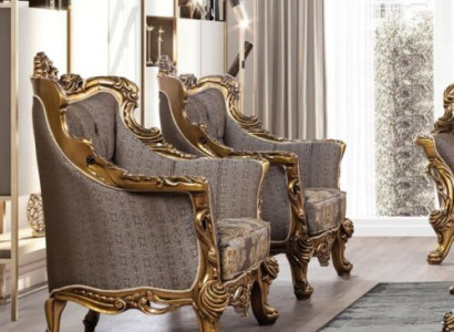 A luxurious Classic r wing chair in dark gray with a golden baroque design from Chesterfield